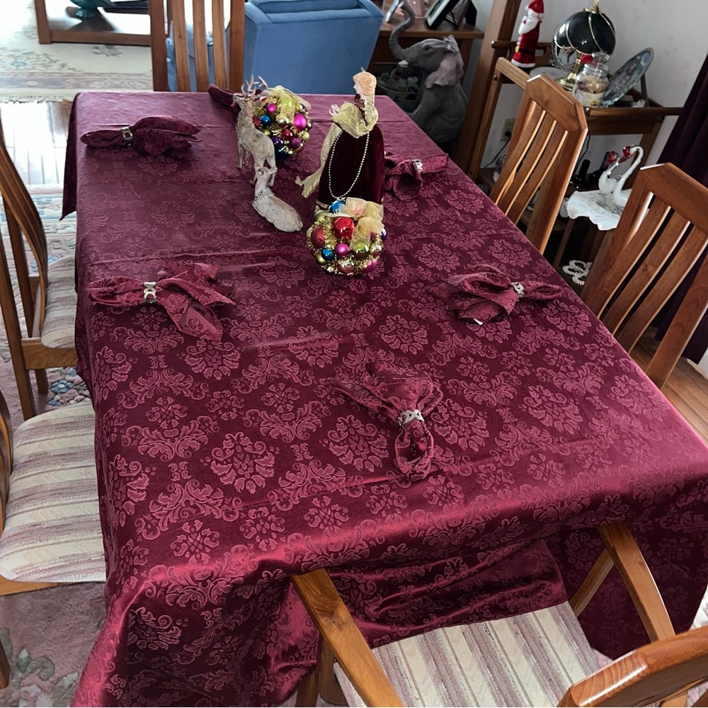 Table cloth, burgundy, and six napkins. Tablecloth 59 x 103 inches.